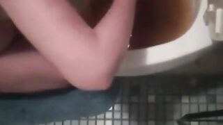 Woman eats her own shit in front of the toilet