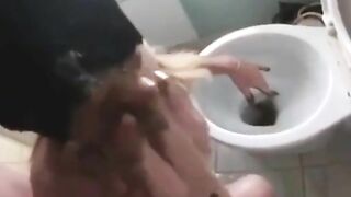 Woman eats her own shit in front of the toilet