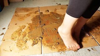 Girl steps in shit and smears it on cardboard