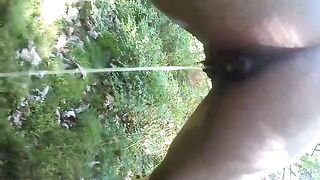 Woman shits in the grass