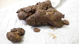 Woman fucks a huge shit pile with a dildo