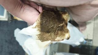 Girl holds a huge blob of shit in her hand