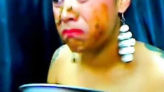 Girl eats shit from bowl while wearing bondage gear