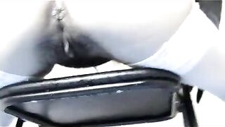 Woman pisses on a metal object