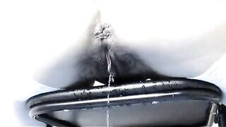 Woman pisses on a metal object