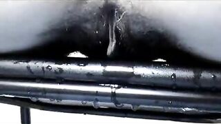 Woman pisses on a metal object