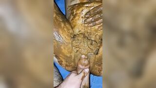 Girl totally covered in shit and playing with it