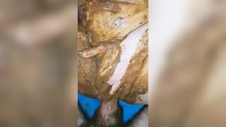 Girl totally covered in shit and playing with it