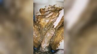 Girl totally covered in shit and playing with it