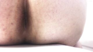 Woman takes a massive shit on a white bed