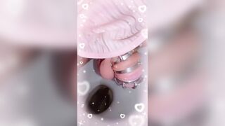 Girl in pink diaper takes a shit in white potty chair