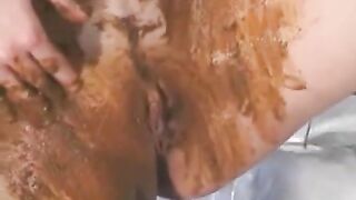 Naked woman smearing shit on her ass