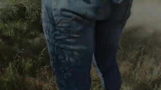 Woman pooping in the grass