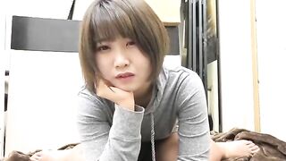 Young Asian woman in gray dress drop shitting