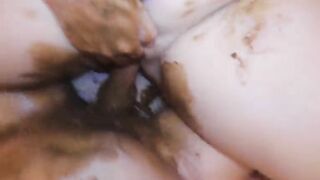 Woman sticks fingers in fresh shit between her legs