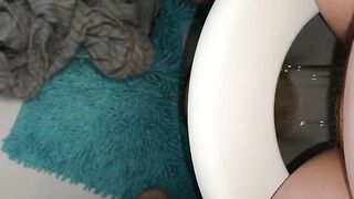 Girl takes a shit on a blue shaggy rug
