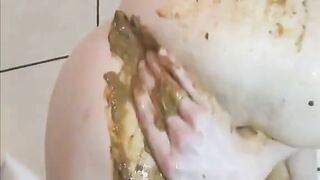Woman squats and plays with her shit on the kitchen floor