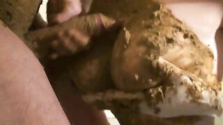 Woman holds a gigantic pile of shit between her legs