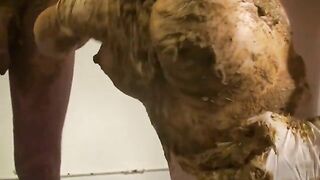 Woman holds a gigantic pile of shit between her legs