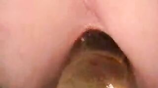 Girl sticks her tongue out while playing with her shit