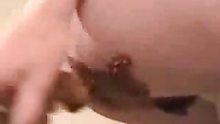 Girl sticks her tongue out while playing with her shit