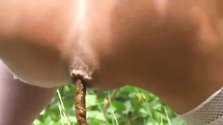 Girl drops a huge shit in the grass while wearing high heels
