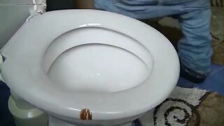 Woman shits on toilet from above