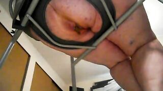 Girl spreads her ass cheeks in a restraint chair and shits