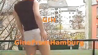 Woman pisses on the balcony of an apartment building