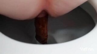 Woman takes a shit while squatting on the toilet