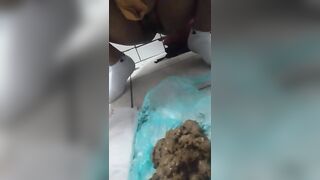 Woman shits in a bathtub full of water