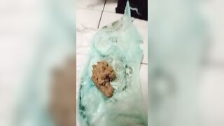 Woman holds a bag of her own shit