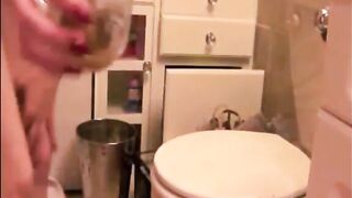Woman lifts a cup of shit from the toilet and drinks it