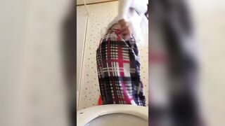 Woman takes a shit on a toilet and wipes her ass