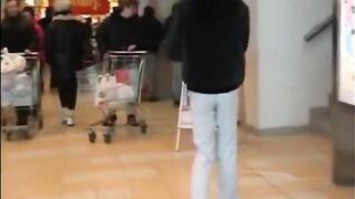 Woman squats in pants and shits on the sidewalk
