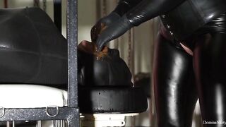 Dominatrix in leather boots eats shit from slave's ass