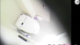 Girl sits on the toilet and poops in her dress