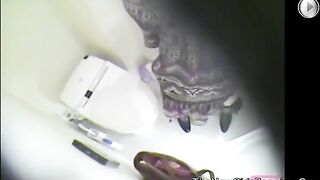 Girl sits on the toilet and poops in her dress