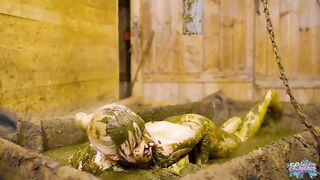 Girl lays in a pile of shit in a wooden room
