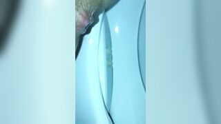 Girl shits in a blue toilet bowl