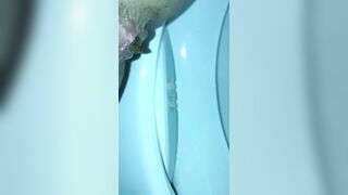 Girl shits in a blue toilet bowl