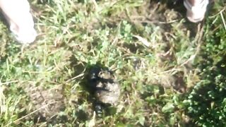 Woman covered in mud and shit outdoors