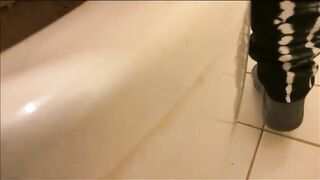 Woman sits on the toilet, letting her shit fill the bowl