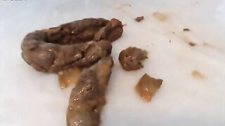 Girl lays on her back with leopard print panties and shits on the floor