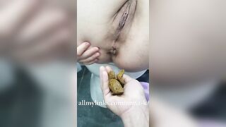 Babe in school uniform eats a huge shit in her hands