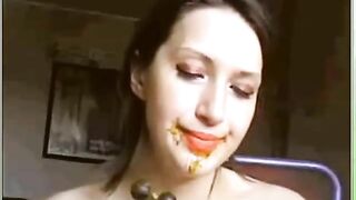 Woman eats shit off a dildo with beads