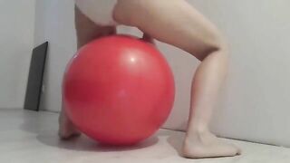 Woman pushes out a pile of shit on a ball while being filmed