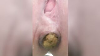 Woman pulls a big turd out of her ass with her finger