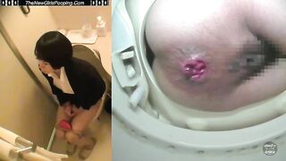 Woman shits in the toilet while looking into the camera