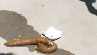 Woman squats and takes a huge shit on the sidewalk
